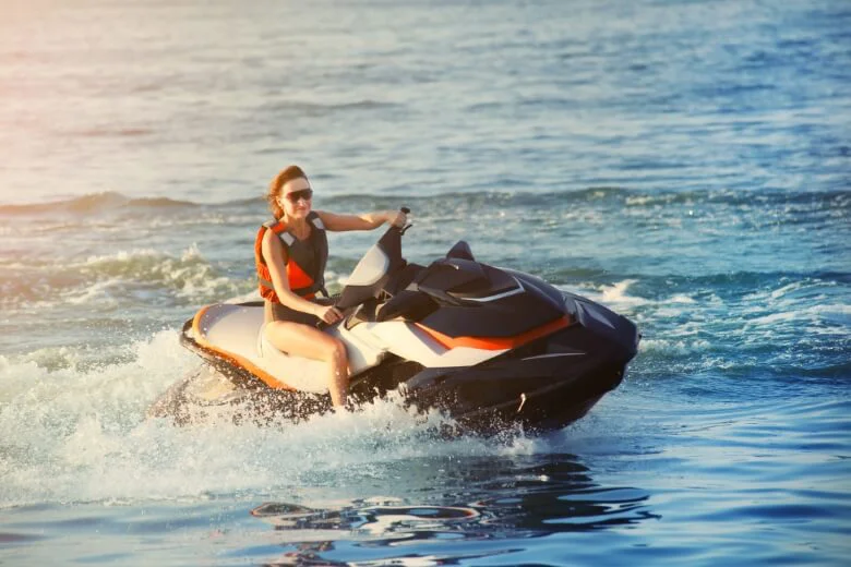 An image of a girl jet-skiing on open water.